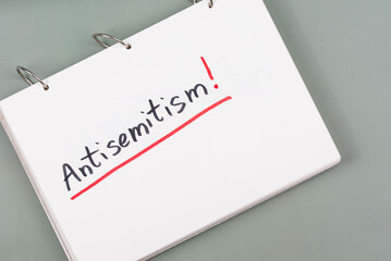Antisemitism minimalistic concept. Word Antisemitism written on white paper with Exclamation point. 