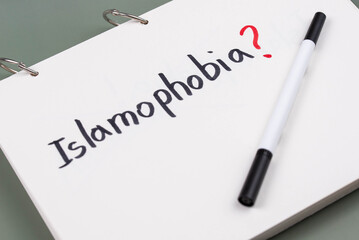 Islamophobia minimalistic concept. Word Islamophobia written on white paper with question mark. 