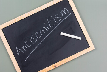 Antisemitism minimalistic concept. Word Antisemitism written on chalkboard with chalk. 
