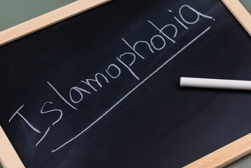 Islamophobia minimalistic concept. Word Islamophobia written on chalkboard with chalk. 