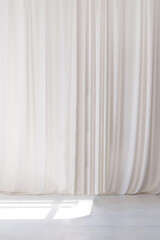 White curtain that dropped down as a straight line. White wooden floor. Background for inserting...