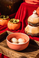 Obraz na płótnie Canvas Chinese traditional festival delicacy sweet soup balls on a wooden tray