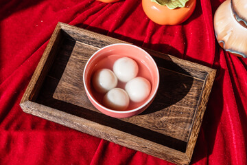 Chinese traditional festival delicacy sweet soup balls on a wooden tray
