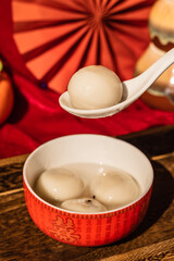 Chinese traditional festival delicacy sweet soup balls on a wooden tray