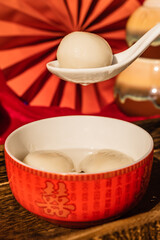 Chinese traditional festival delicacy sweet soup balls on a wooden tray