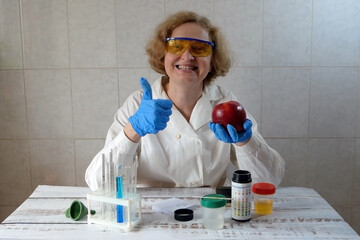 Medical laboratory assistant taking apple on  test tube with liquids background, test with urine,...