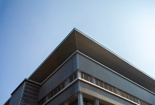 The corner of a modern building with a play on lines and geometry. Minimalist and modern architectural style.