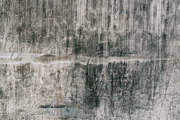 Grunge style urban weathered shabby  peeled painted concrete unique moody surface of the wall with holes, dirty scratches and cracks macro background