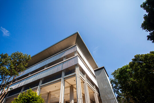 The corner of a modern building with a play on lines and geometry. Minimalist and modern architectural style.