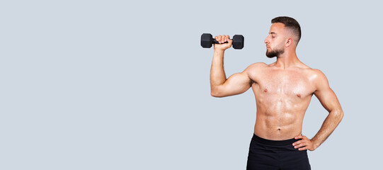 Focused sweat calm handsome strong muscular young european guy with beard, naked torso make exercises with dumbbell