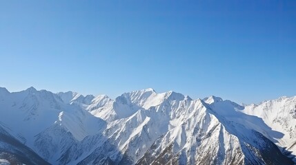 Fototapeta na wymiar Snow-Capped Mountain Panorama: White Peaks and a Blue Sky