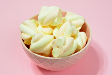 yellow marshmallows in pink bowl close up  