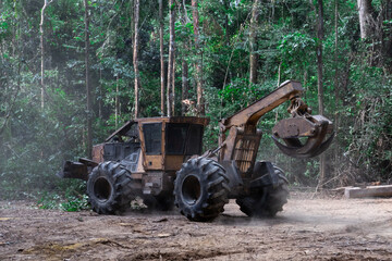 Skidder machine used for dragging logs freshly harvested from a sustainable forest management area in the heart of the Amazon rainforest