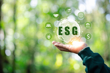 ESG icon concept in the hand for environmental, social, and governance in sustainable and ethical business on the Network connection on a green background. environmental icon, banner and copy space