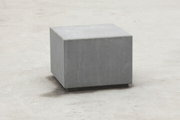 Urban architecture concept. Big gray cube on concrete background. Copy-space. Outdoor shot