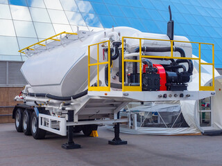 Tank semi-trailer for transportation liquid cargo. Cement truck with motor for mixing. Industrial...