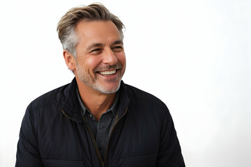 Fototapeta premium Portrait of a handsome middle-aged man smiling and looking at camera over white background