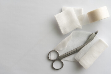 Dressing or clean wound tools includes Roll gauze,pile of gauzes and gauze roll cutter or scissors