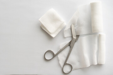 Dressing or clean wound tools includes Roll gauze,pile of gauzes and gauze roll cutter or scissors