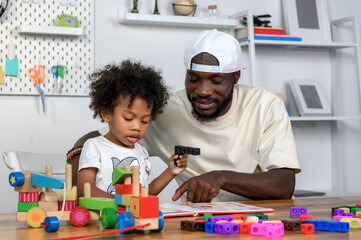 Father is Reading a Book to The Child. The Father is Helping The Child Develop Their Language Skills and Imagination. Father Fosters Language Skills in Child Through Storytelling.