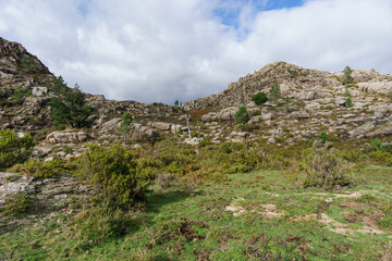 Fototapeta na wymiar Mountain landscape of granite rocks with green vegetation, Peneda-Geres National Park, Vilar da Veiga, Portugal