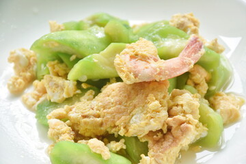 stir fried ridge gourd with egg stuffed shrimp in soy sauce on plate