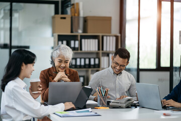 Group of Young Asian business team creative businesspeople coworker in office. Meeting Presentation for analysis graph company financial. People Work in Business Office.