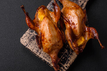 Roasted quail, partridge or pigeon stuffed with orange with spices and herbs