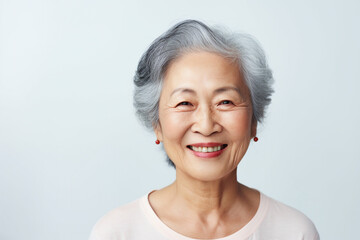 Senior woman with an anti-aging regimen, on a white background - obrazy, fototapety, plakaty