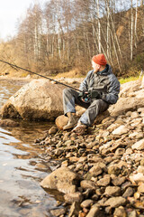 fisherman fishing on the river bank, Fishing rod, spinning