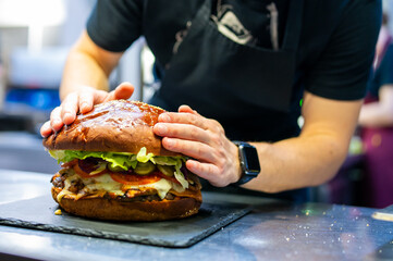 chef hand cooking big large cheese burger on restaurant kitchen. step by step
