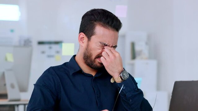 A stressed and overworked male administrator with a headache and hectic deadlines. A frustrated male information manager with a migraine at his workplace. A tired data analyst overwhelmed by work