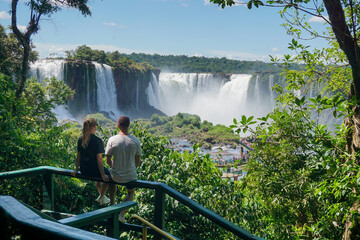 Man and woman looking at the Iguazu waterfalls