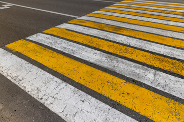 white and yellow pedestrian crossing on the road