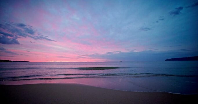 Colorful dramatic cloudscape over sea horizon at sunrise