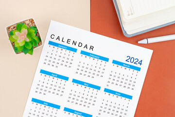 Calendar Year 2024 and pen with diary.