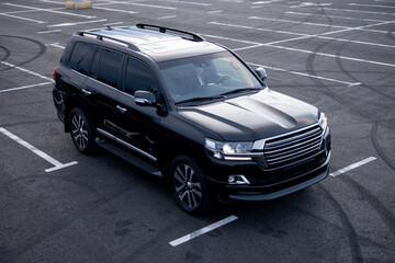 Luxury black SUV car on a parking lot, view from above. Business transfer serfice concept and...