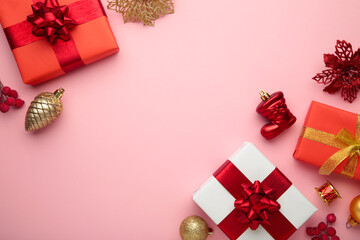 Christmas composition. Gifts, red and gold decorations on pink background. New year concept.