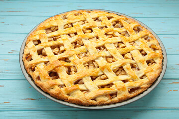 Homemade sweet american apple pie with sugar and cinnamon. Tart on blue wooden background.