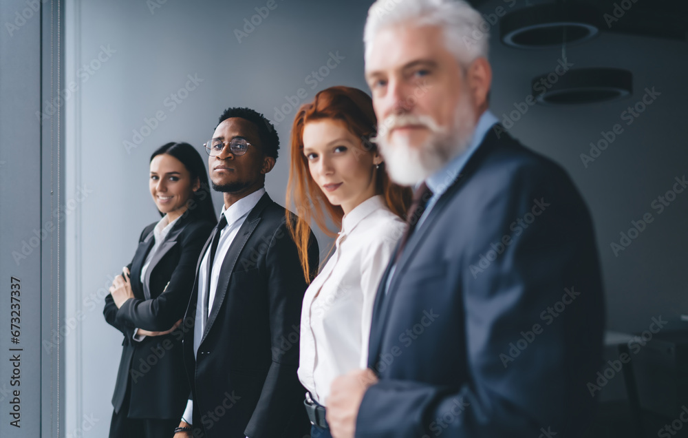 Sticker Positive diverse coworkers standing near window in office