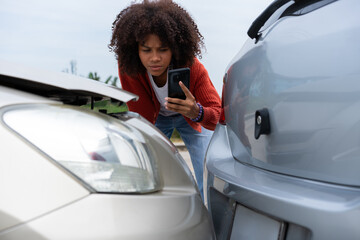 Half Thai African driver check for damage after a car accident before taking pictures and sending insurance. Online car accident insurance claim after submitting photos and evidence to an insurance. - obrazy, fototapety, plakaty