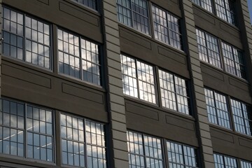 Fototapeta premium Large brown building with modern glass and concrete windows
