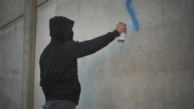 antisemitism xenophobia person drawing painting jewish david star symbol on the building wall with a spray can