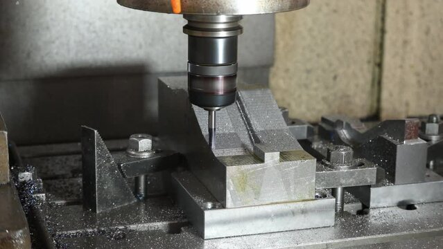The CNC milling machine cutting press die part by solid ball end mill tool and G-code data background.