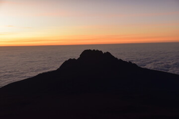 Orange sky at a beautiful sunset above the clouds on Mount Kilimanjaro in Tanzania, Africa