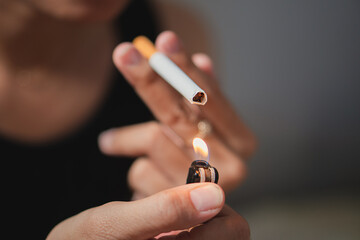 Smoker lighting a cigarette with lighter