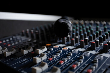Microphone with audio mixer in the control room audio system.