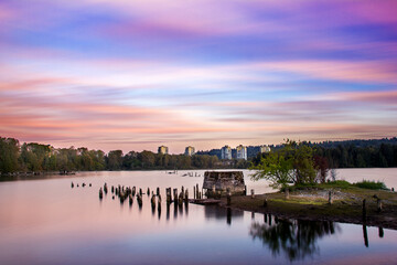 Obraz premium Long, empty pier stretches along the lake during a peaceful dusk hour