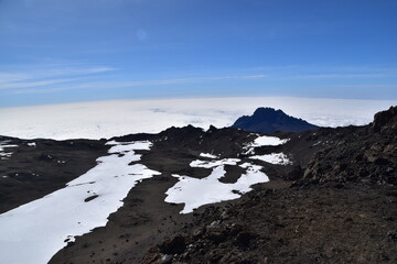 Hiking at high altitude above the clouds on Mount Kilimanjaro in Africa