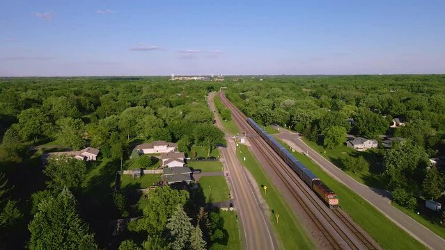 Time-lapse view of a train traveling next to a residential neighborhood